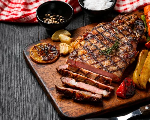A perfectly seared, highly marbled Wagyu Akaushi full-blood steak cut and served at a luxury Houston restaurant
