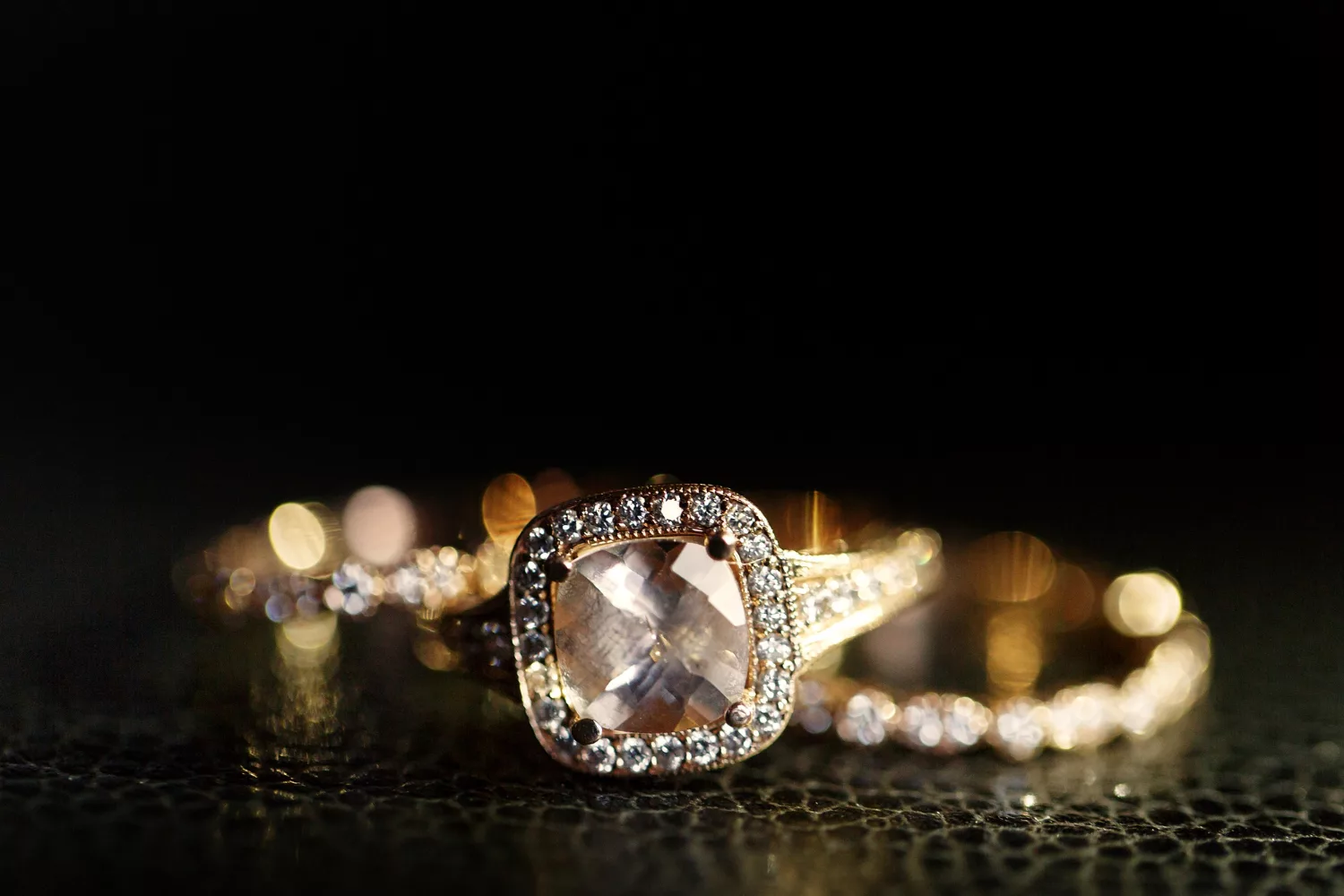 Diamond halo engagement ring with bokeh lighting — luxury jewelry Houston