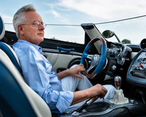 Horacio Pagani standing alongside a Pagani Utopia hypercar