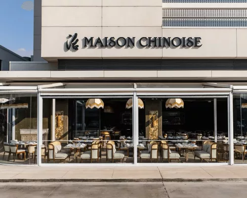 The luxurious interior dining room of Maison Chinoise in River Oaks Houston featuring warm ambient lighting